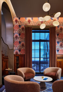 A luxurious lobby at the W Hotel, adorned with exquisite art deco wallpaper, exuding elegance and charm.